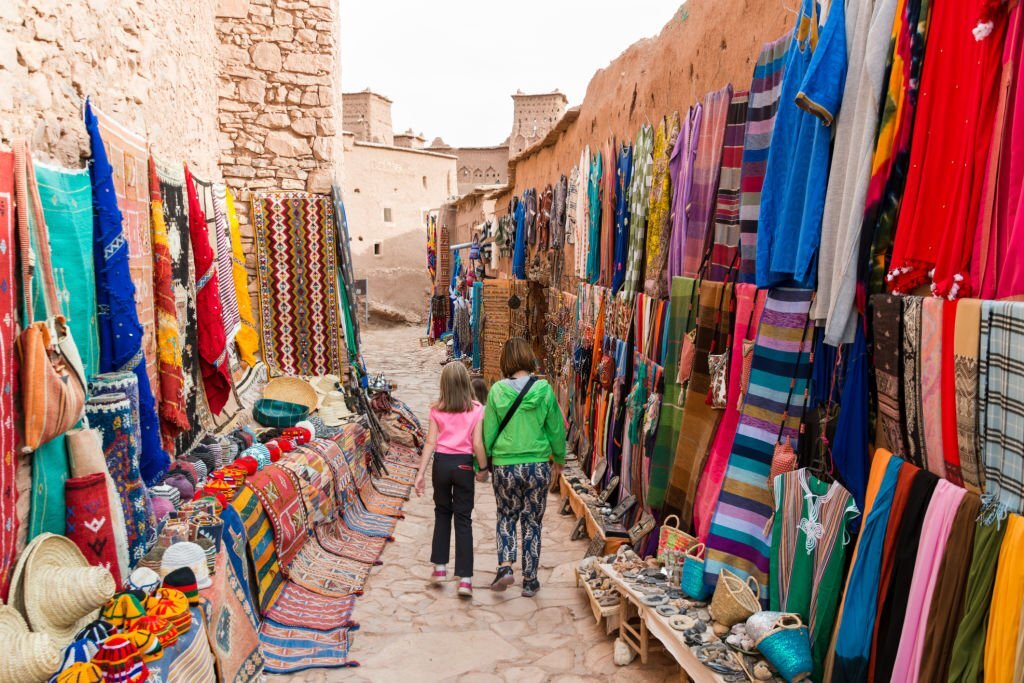 Horizontal image mother and daughter walking on streets of Ait Benhaddou fortress, Morocco. Ksar Ait Benhaddou is a fortified village near Ouarzazate, on the old caravan route between Sahara and Marrakesh.