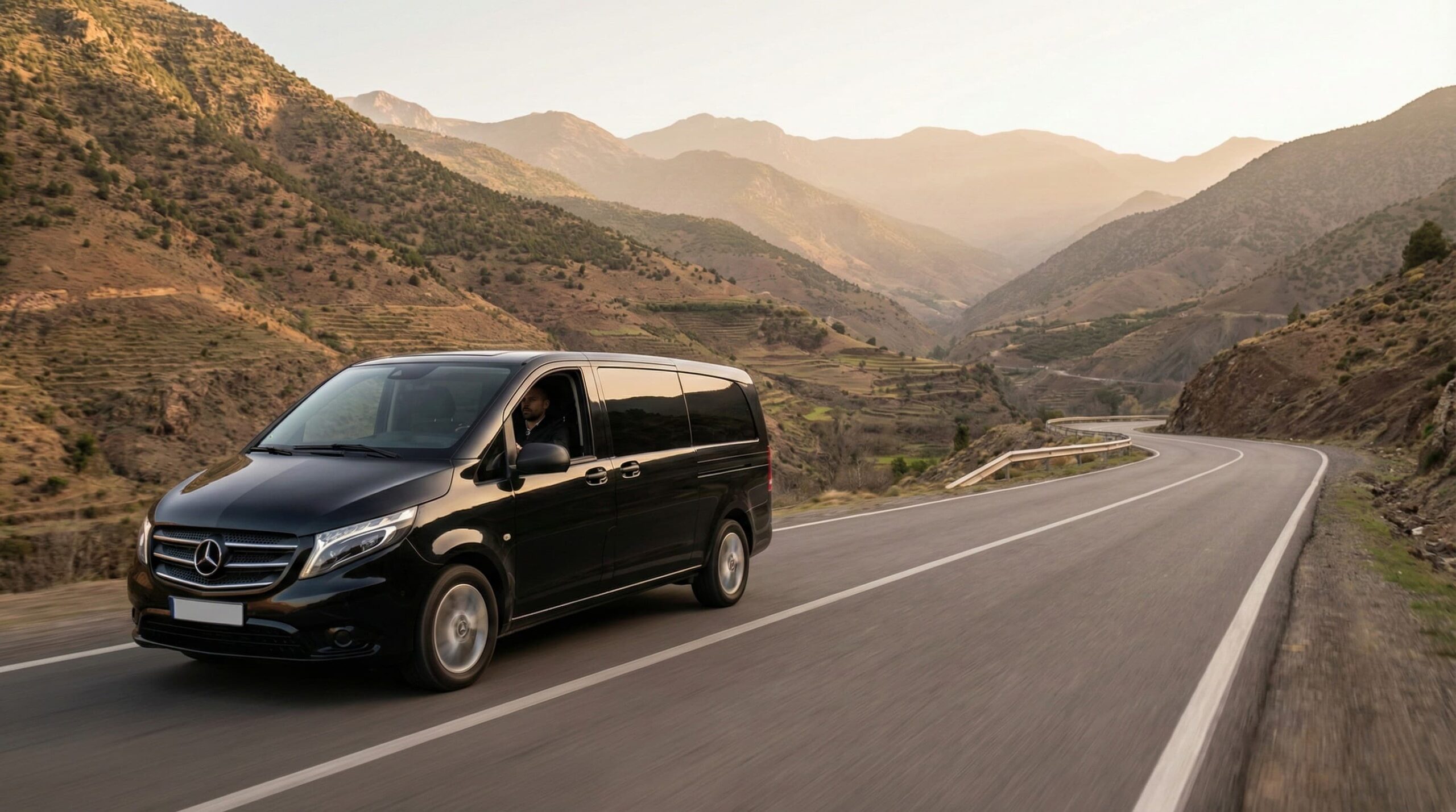 Black Mercedes Vito private chauffeur service in Morocco on a scenic road